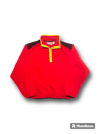 a red and yellow sweatshirt on a black background