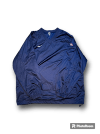 a blue nike jacket on a black background